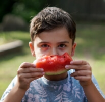 A boy eating a watermelon in Texas.