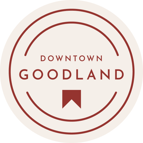Logo of new homes in Goodland TX featuring a circular design with text and a geometric emblem.