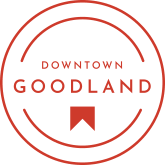 Logo of downtown Goodland with a circular design and an upward-pointing arrow, symbolizing new homes in Goodland TX.