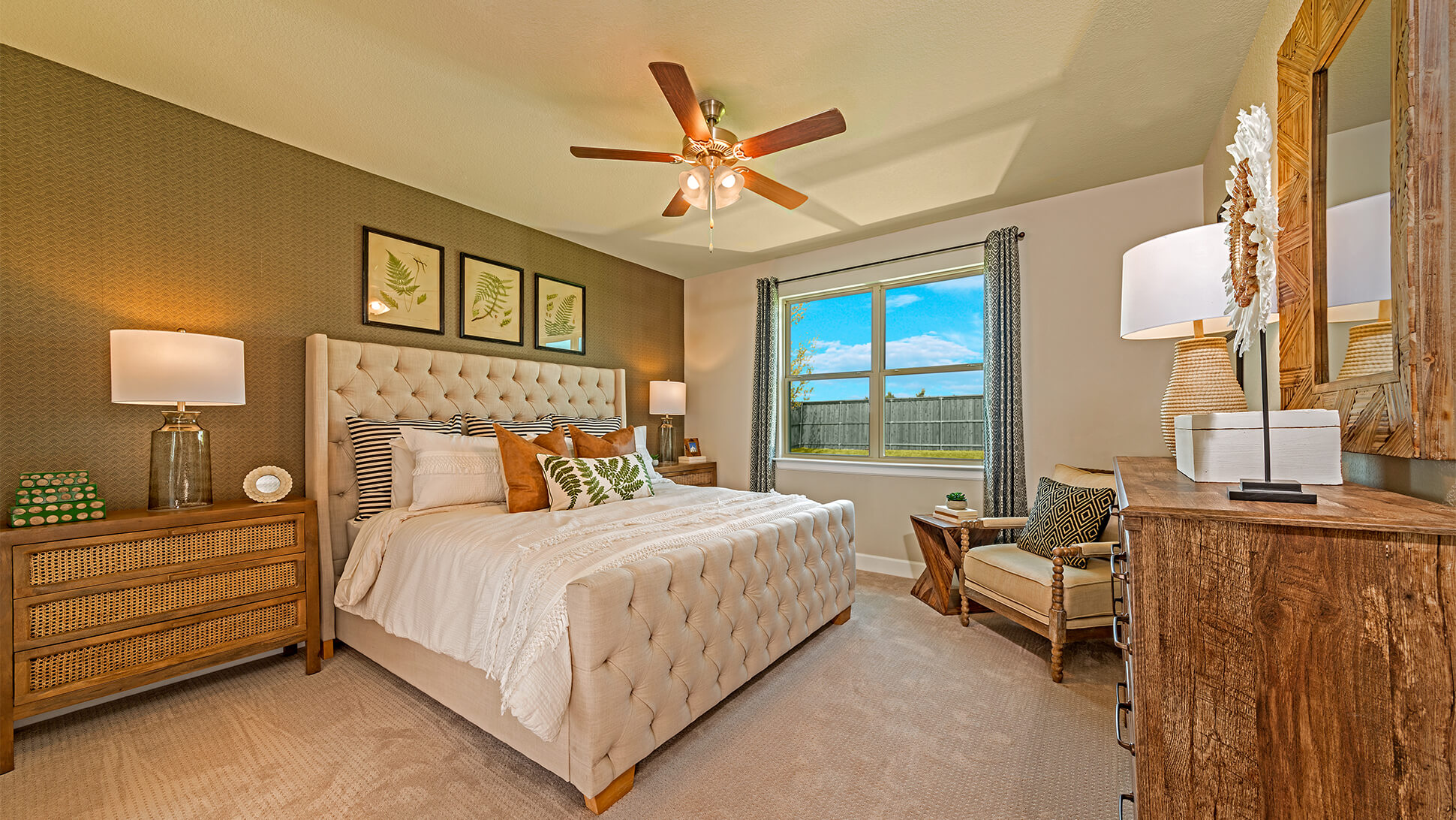 Bright and cozy bedroom in a new home in Mansfield, TX, with a neatly made bed, warm lighting, and a view of the outdoors.