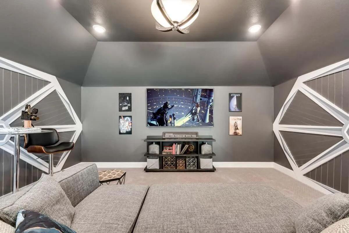 A modern living room with geometric wall shelves, a mounted television, and sci-fi themed decor, perfect for new homes in DFW.