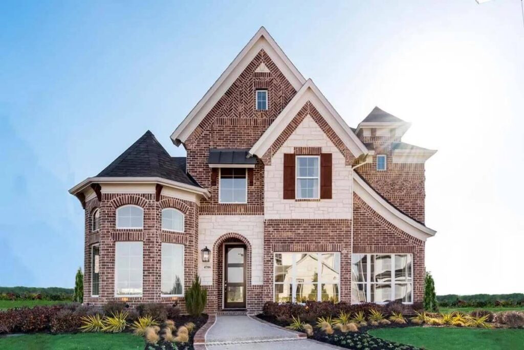New two-story brick house with a clear blue sky background in Mansfield TX.