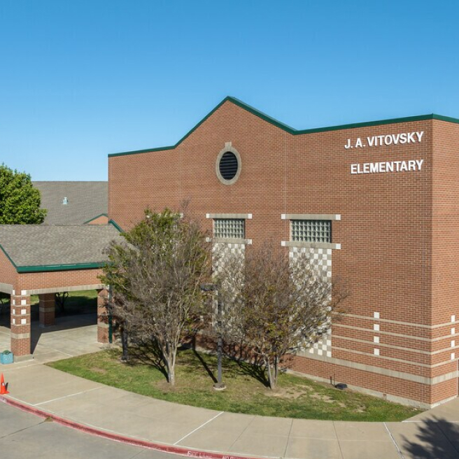 Exterior of J.A. Vitovsky Elementary School building on a sunny day, near new home communities in Mansfield, TX.