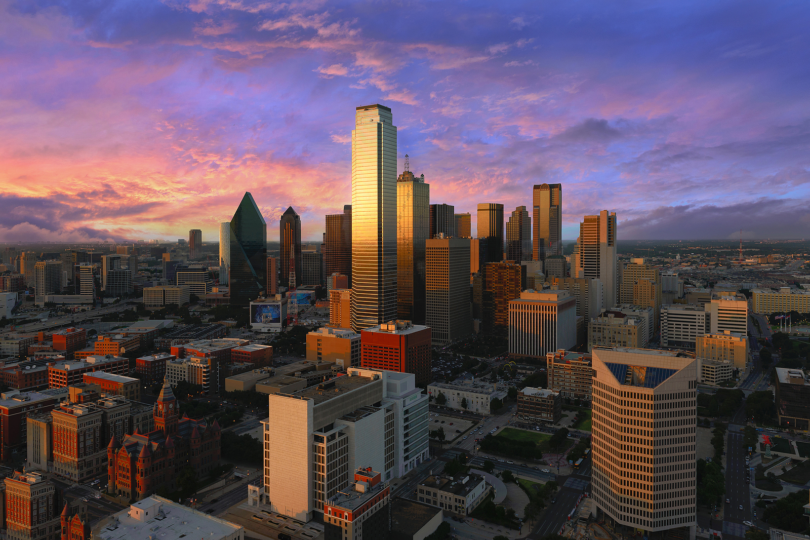 Aerial view of a city skyline at sunset with cloudscape featuring new home communities in Mansfield TX.