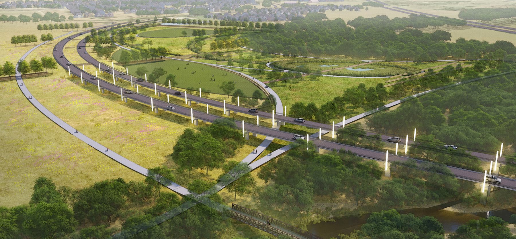 Aerial view of a wildlife overpass allowing animals to cross over a highway amidst green landscapes, near new home communities in Mansfield TX.